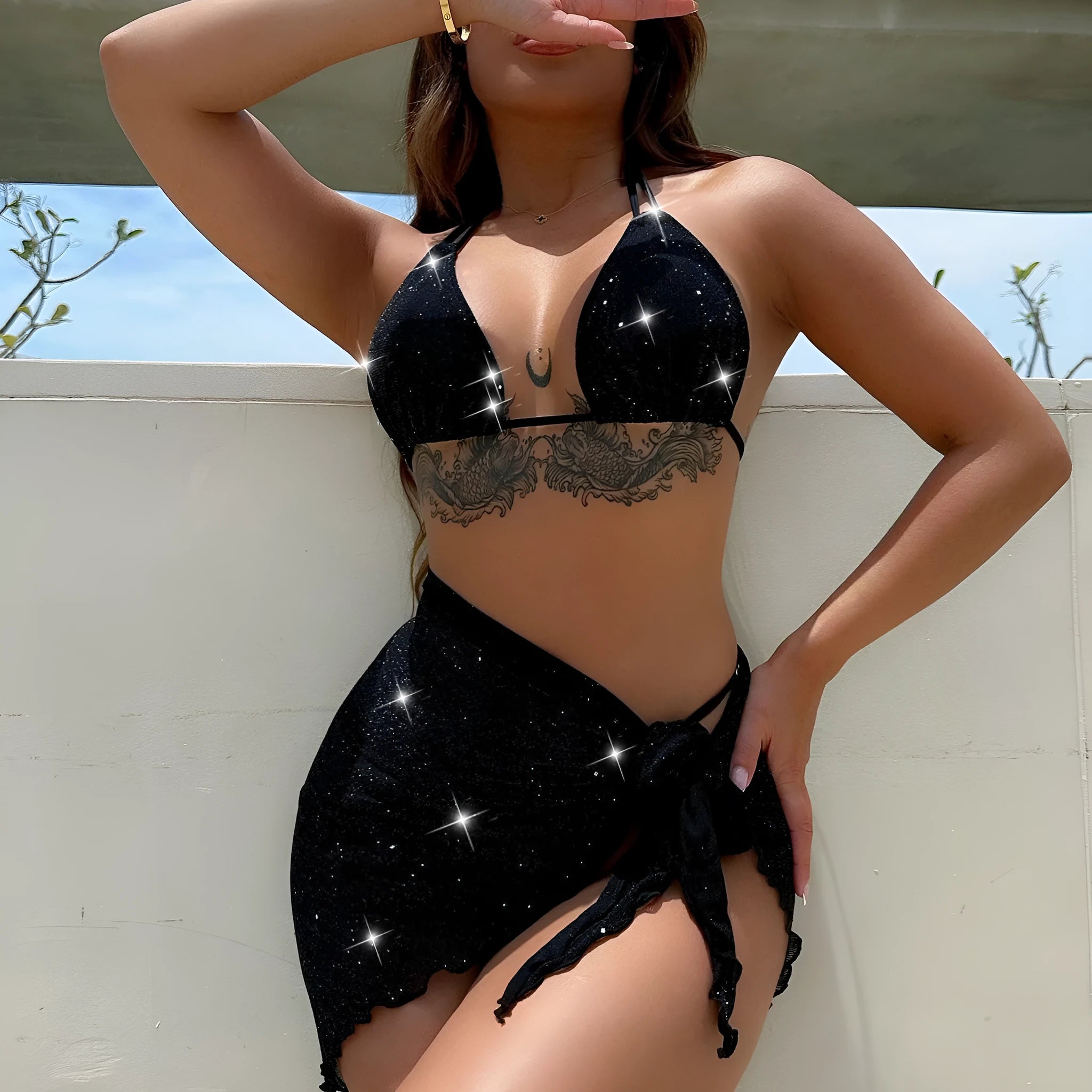 Black women's three-piece ruffled bikini set with matching shorts on a mannequin.