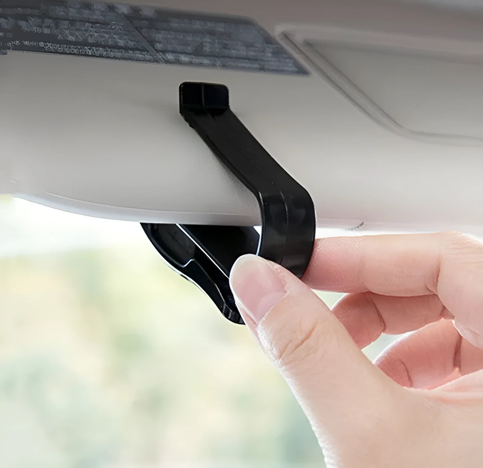 Black plastic car sunshade clip for holding glasses, tickets and ID cards, dimensions 6.5 by 2.3 centimetres