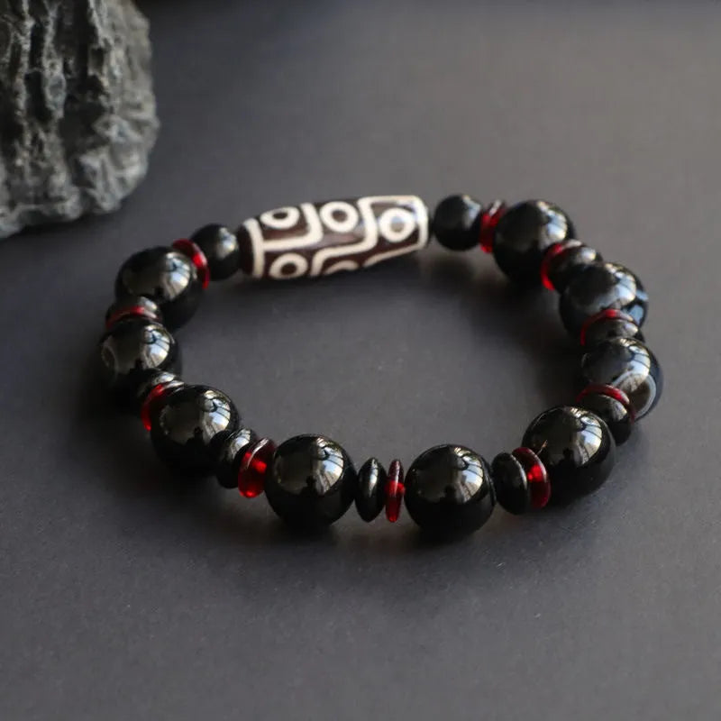 Black agate dzi bead bracelet with hand-woven construction and 11mm geometry beads