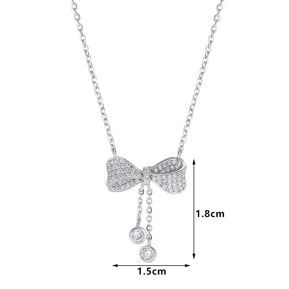 Silver bow necklace on adjustable chain showing pendant detail and polished finish