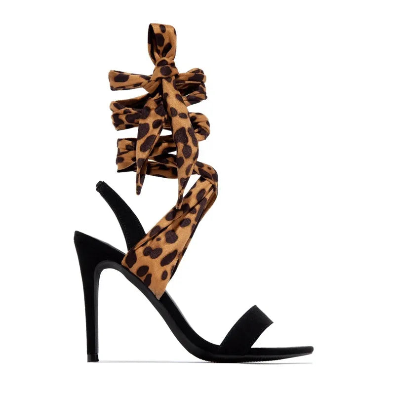 Light brown leopard print women's high-heel sandals with cross straps and a fine high heel.