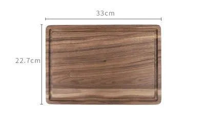 Black walnut wood chopping board with juice groove, shown in round and rectangular sizes on a kitchen counter.