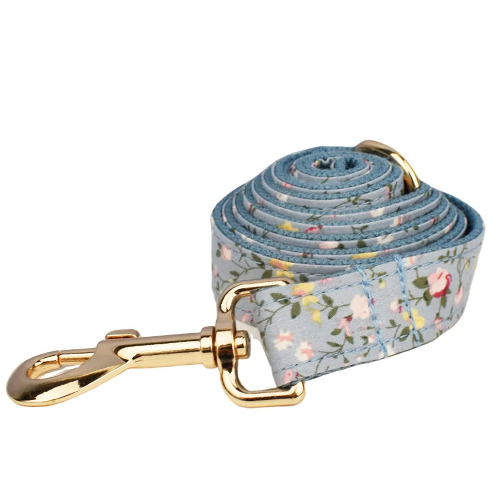 Blue floral patterned cloth dog collar with matching leash, vest, bow, and poop bag set for pet gifts