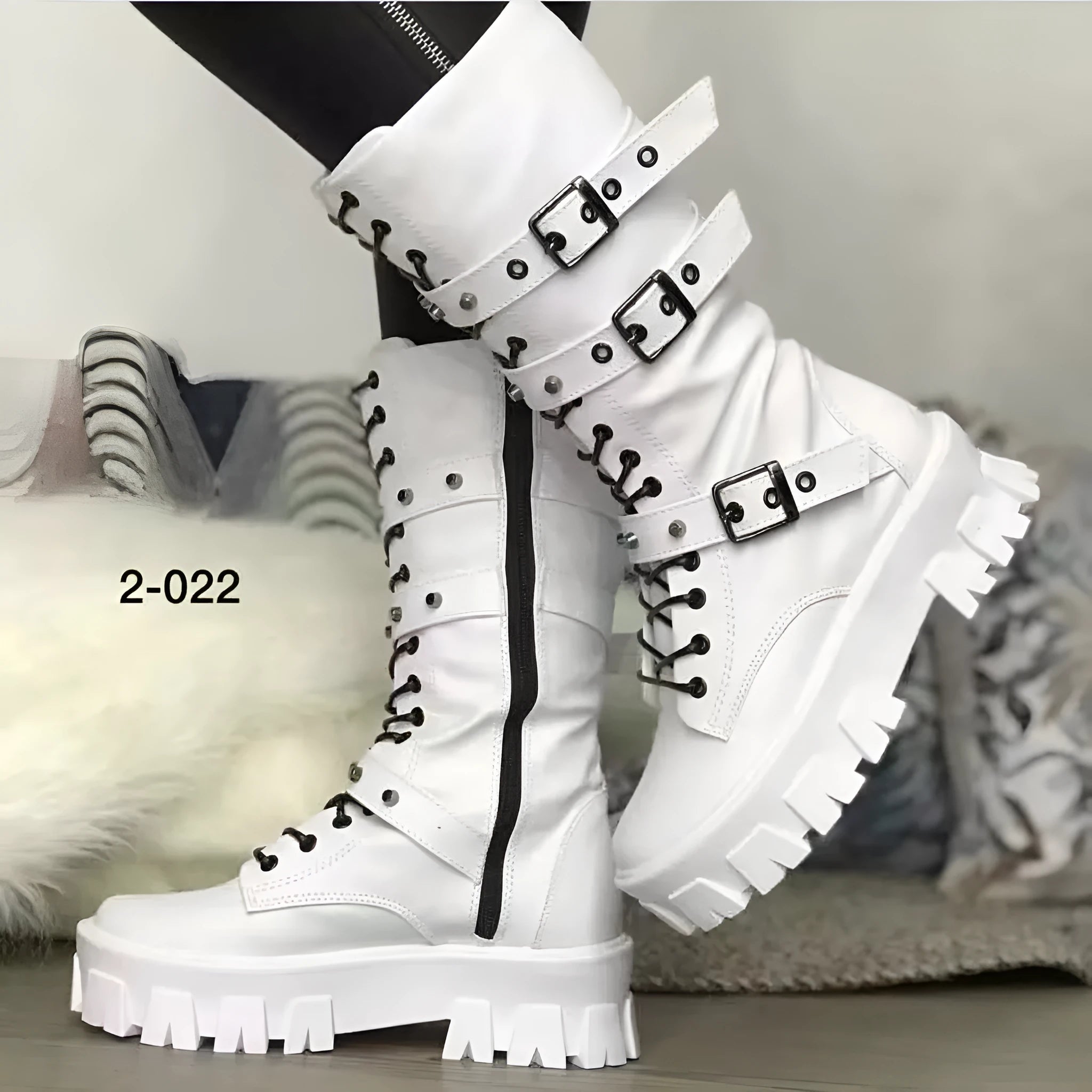 Women's black mid-calf knight boots with metal buckle and side zipper on a round toe.
