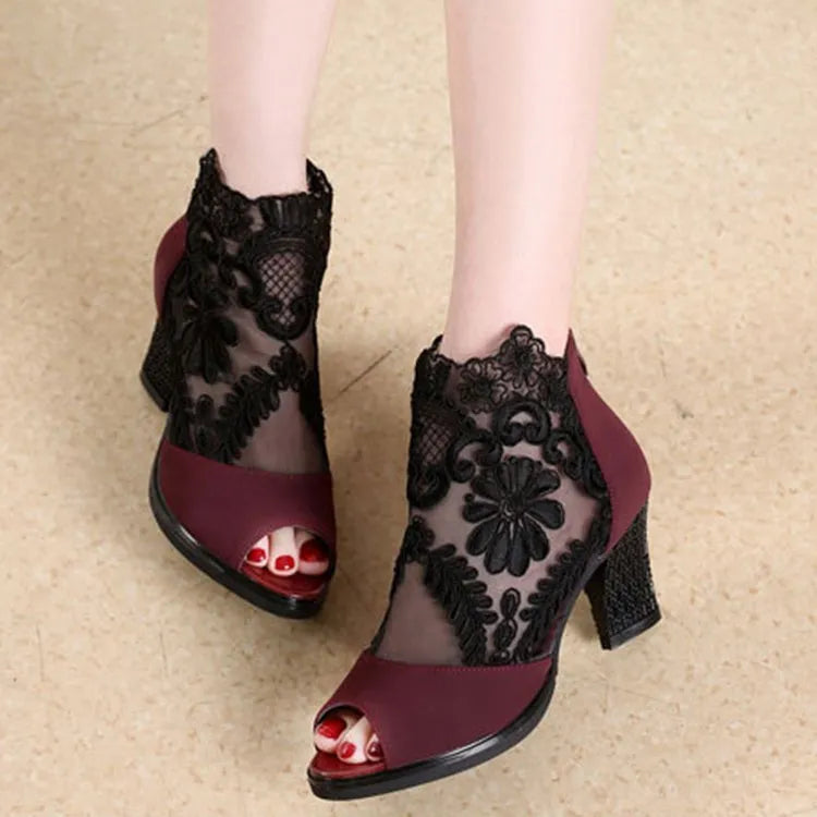 Black gladiator sandals with lace upper, square high heel, and zip closure on ankle