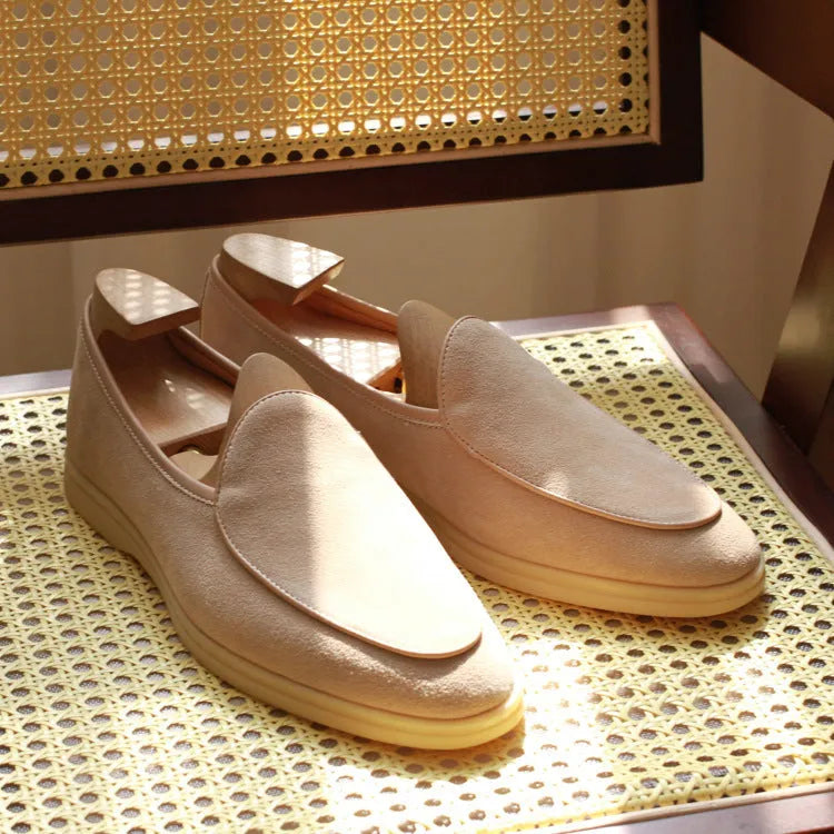 Men's brown handmade leather loafers with a flat TPR sole on a white background.