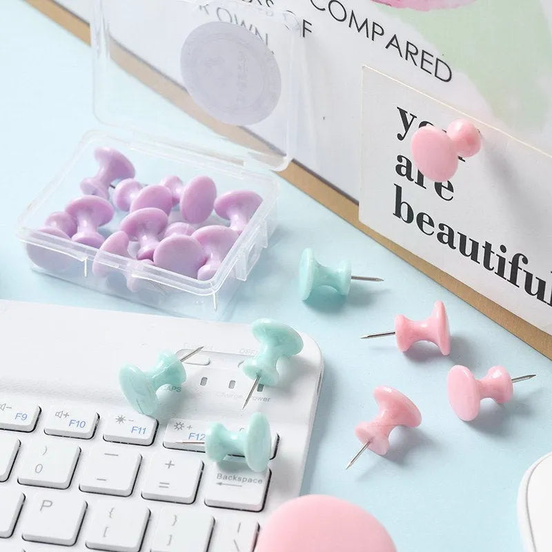 Plastic push pins in cherry blossom pink, mint green, and lavender colours, showing both large and small sizes in a box.