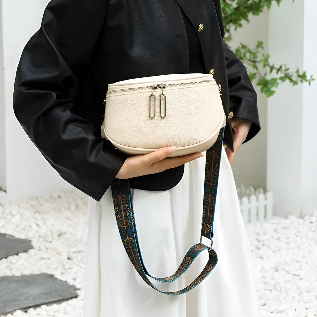 Women's soft PU leather messenger bag in saddle shape with single strap and zipper pocket