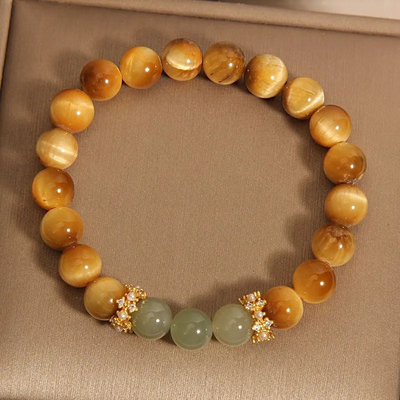 Natural Yellow Tiger's Eye and Hetian Jade beaded bracelet with gold gourd or bamboo joint design.