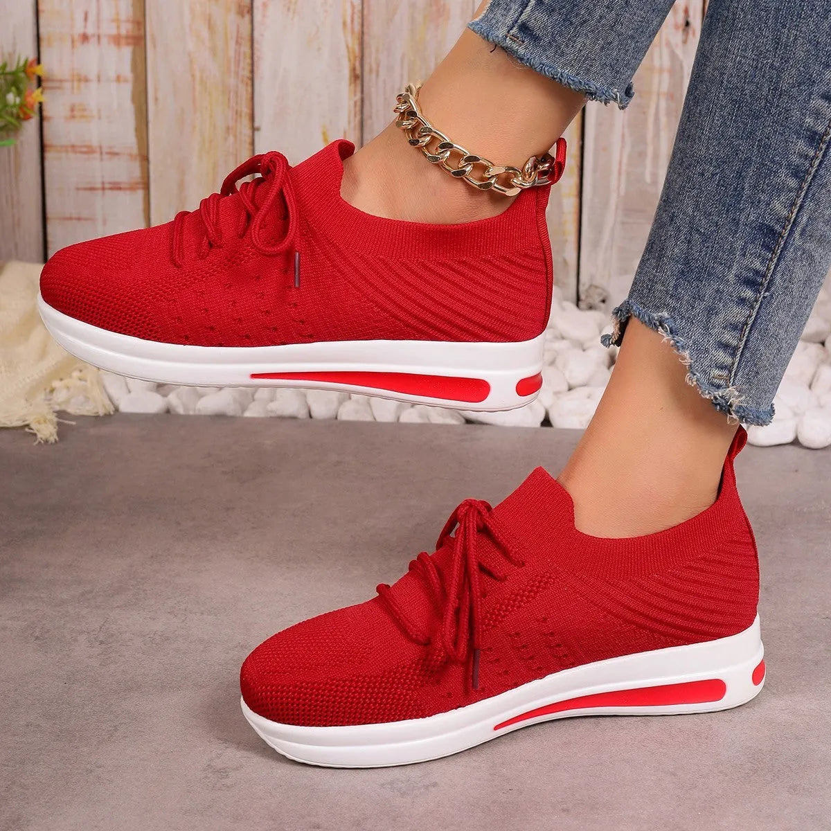 Women's low-top casual sneakers in black, blue, and red with a fly-knit PU upper and front lace-up closure.