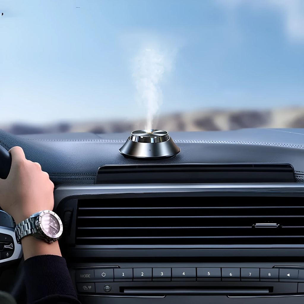Black metal butterfly-shaped car aromatherapy diffuser with USB cable and 50ml essential oil bottle.