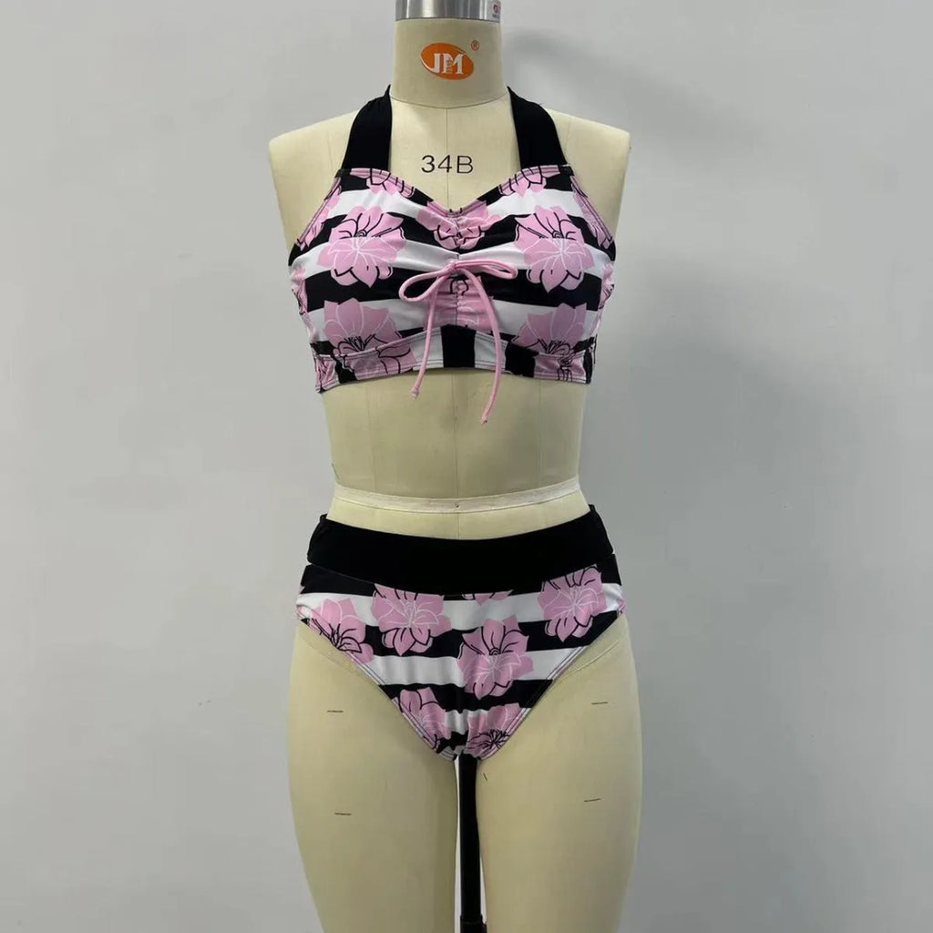 Black printed women's bikini with slimming belly panel and split-leg bottoms.