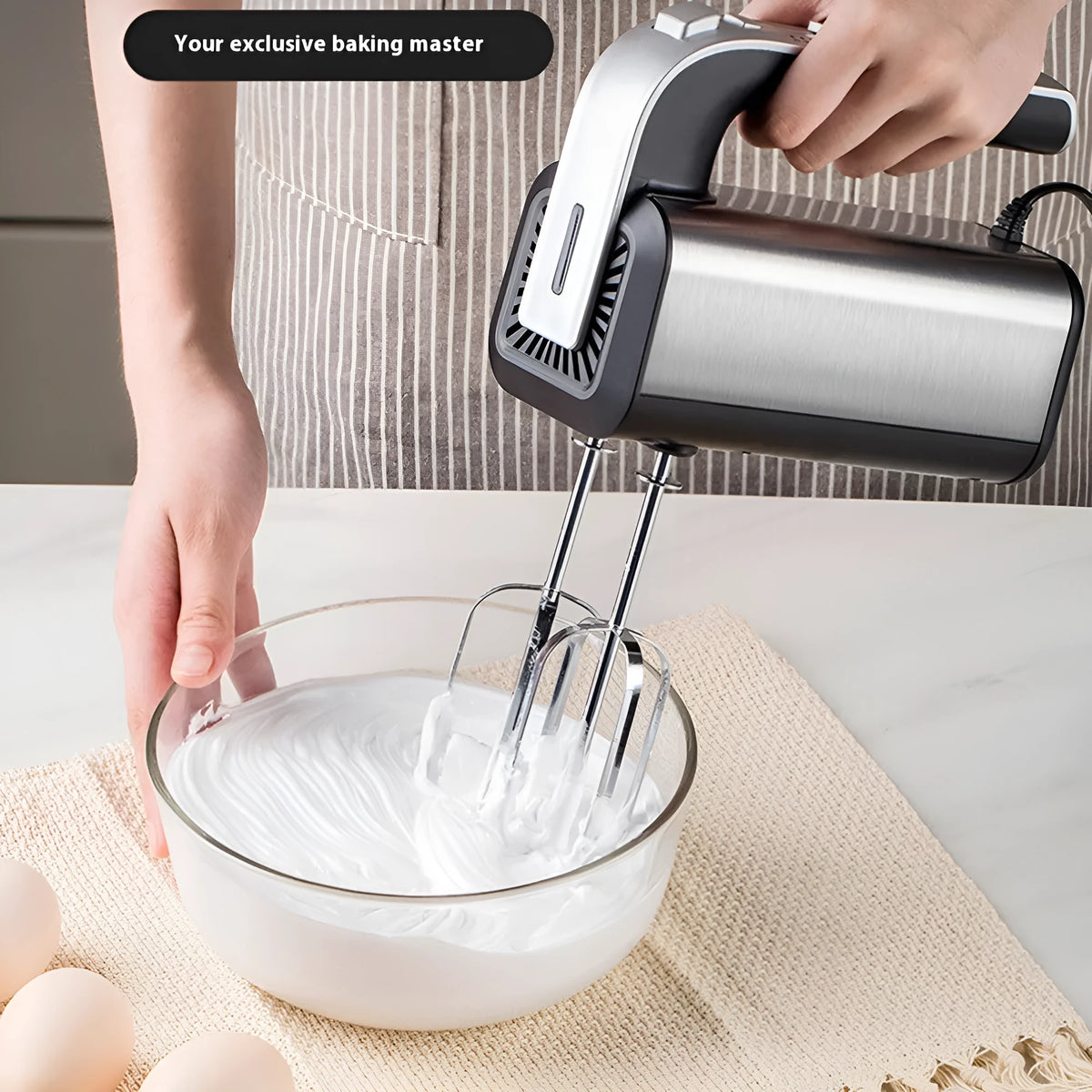 Silver handheld electric kitchen whisk with stainless steel beaters and speed control dial