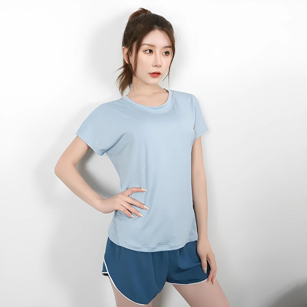Women's short sleeve polyester sports t-shirt in sky blue, shown on a model.