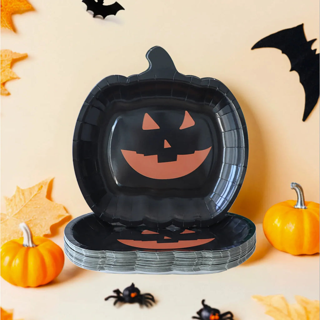 A pack of black disposable paper plates with a pumpkin design for Halloween, shown in 9-inch size.