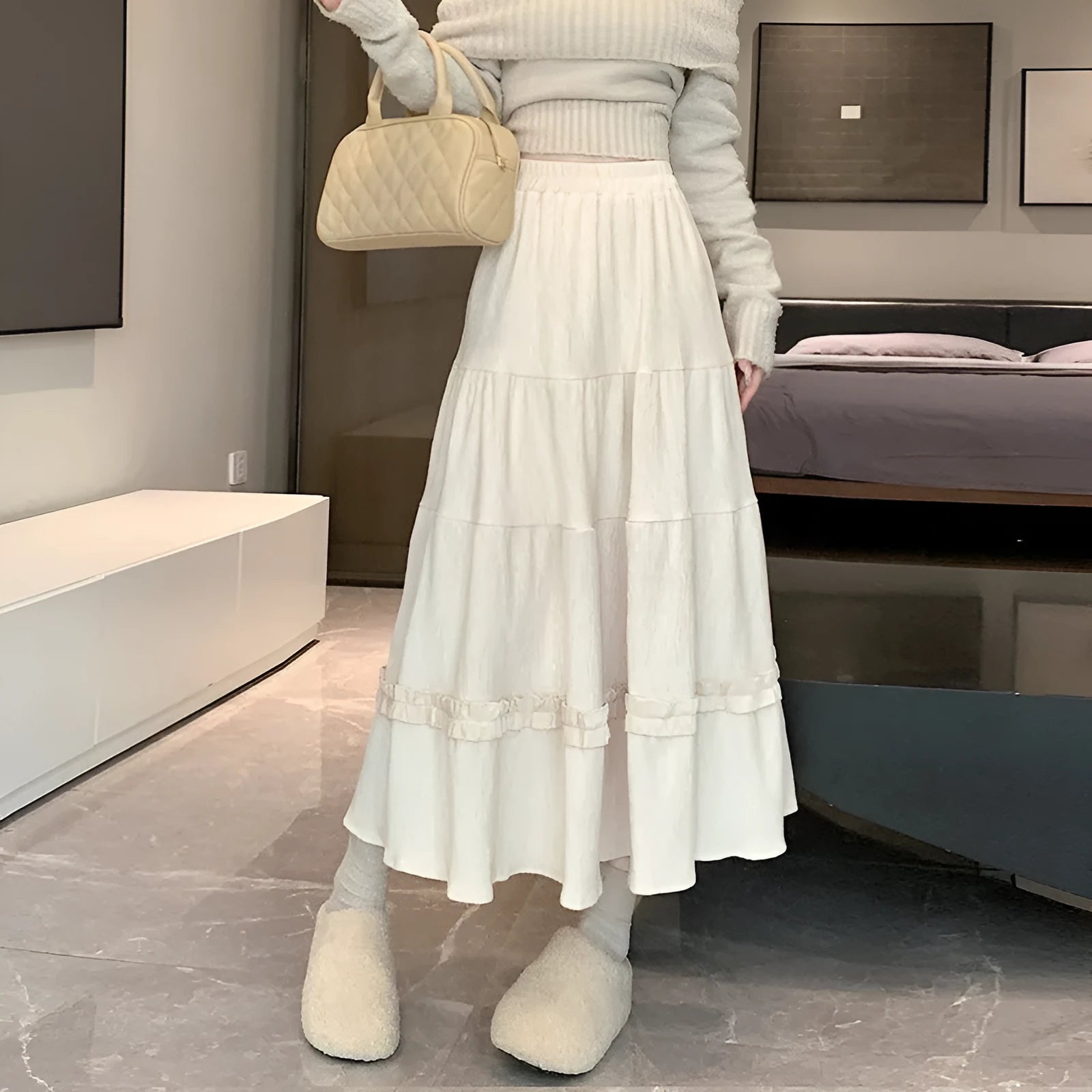 Korean style beige corduroy A-line midi skirt with an elastic waistband on a hanger.