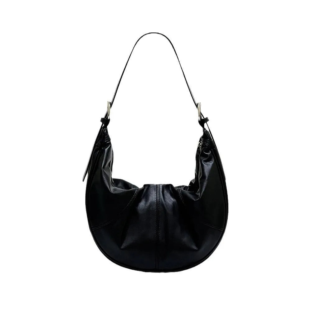 Women's soft cowhide leather shoulder bag in dumpling shape showing double straps and sandwich pocket.