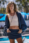 Women's blue polyester hooded jacket and matching miniskirt streetwear two-piece set.