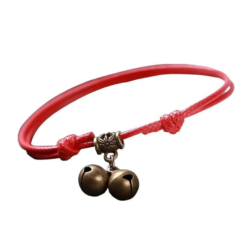 Small dog collar made of nylon rope with a brass bell, shown in black colour.