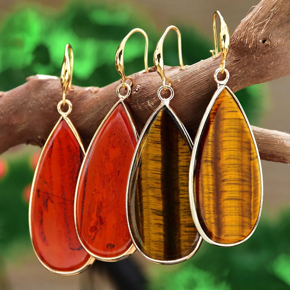 Vintage long drop earrings made from stone with a water droplet texture, shown in Tigereye colour.