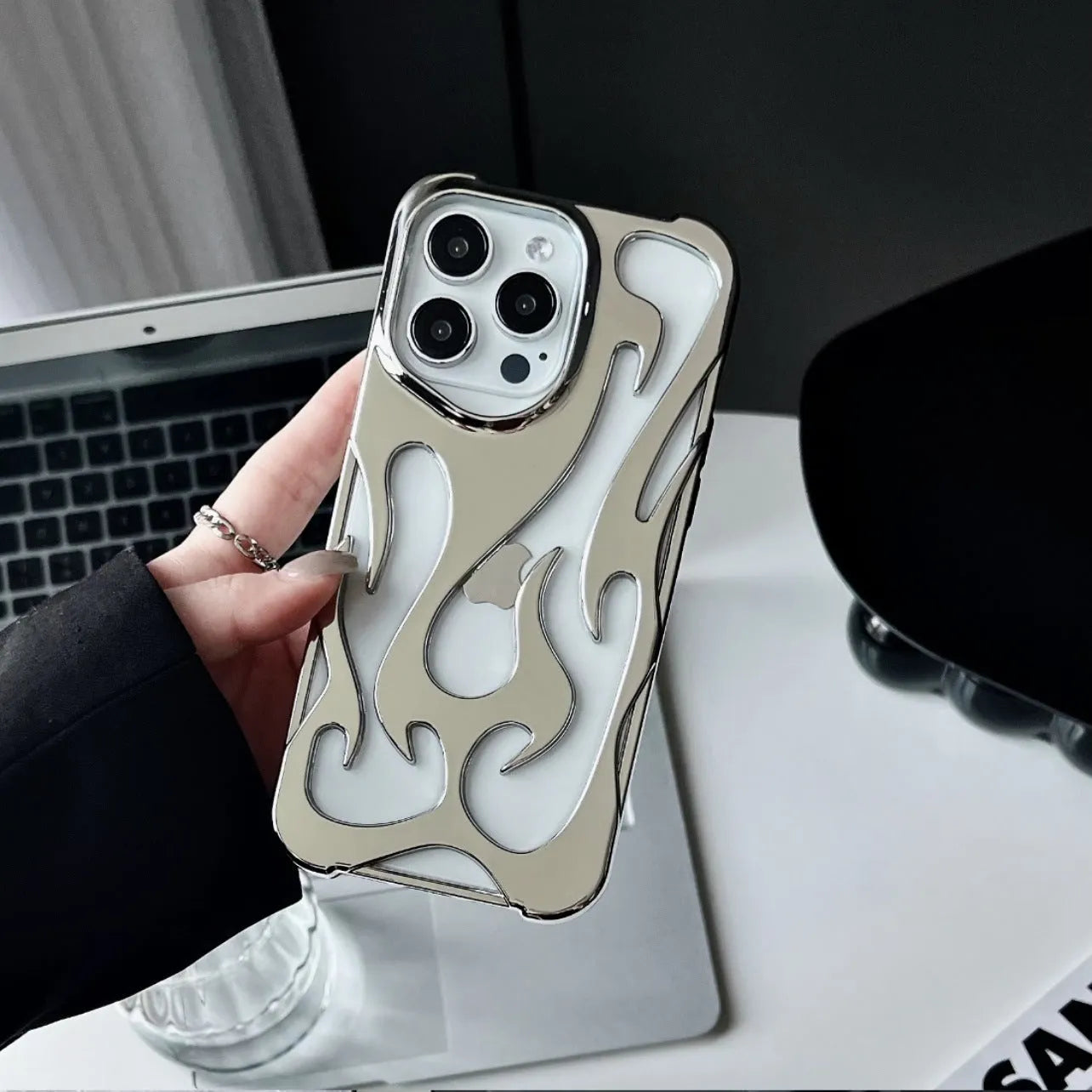 Electroplated iPhone case with hollow flame pattern design in gold, black, purple, and silver finishes