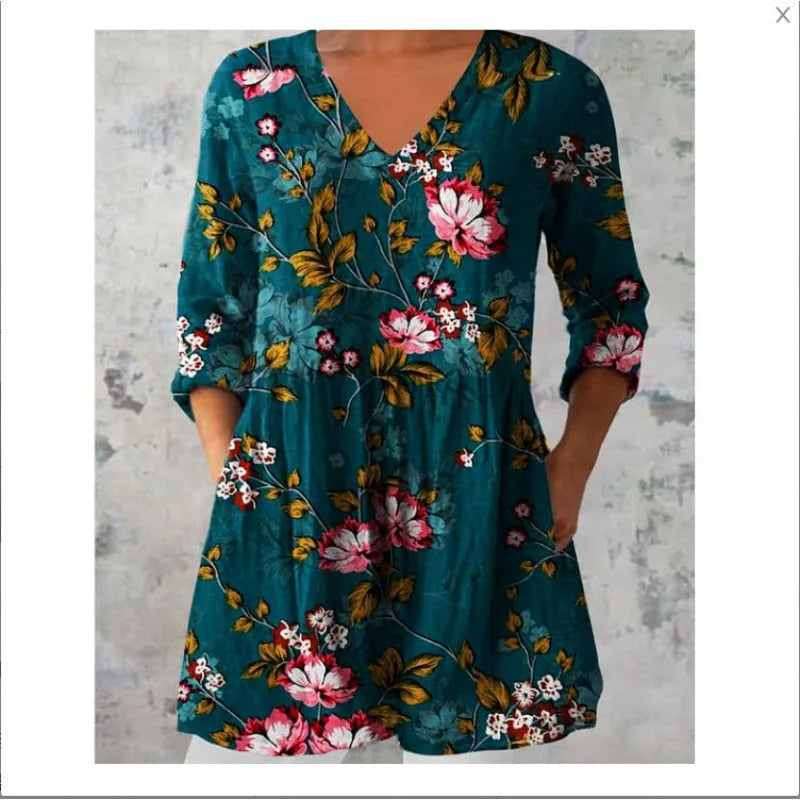 Women's loose-fit dress with a blue and white wave print, wide waist, and 3/4 length sleeves.