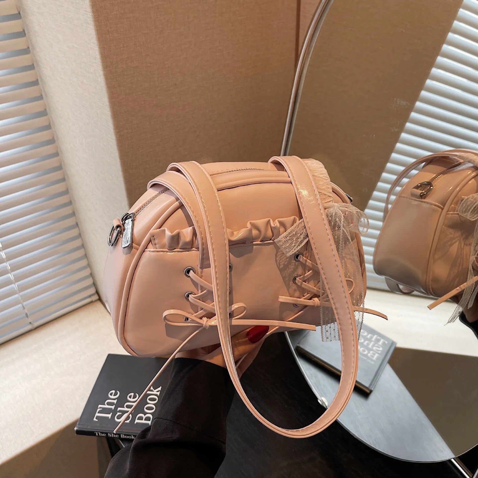 Women's white PU leather shoulder bag with a large bandage bow detail on the front.