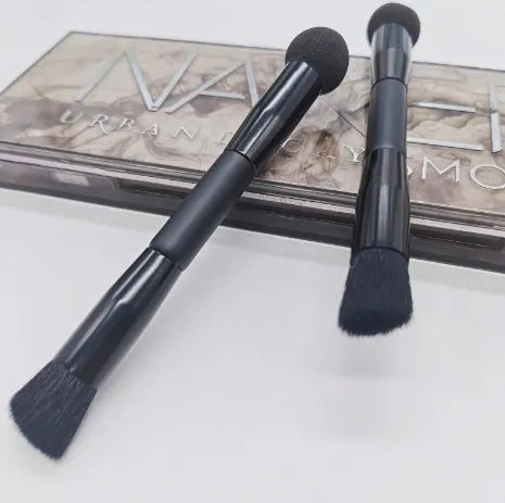 Elegant black double-headed concealer brush with miter sponge and synthetic bristles on a wooden handle.