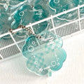 Acrylic four-leaf clover charm on a keychain for mobile phone decoration, shown in blue, green, and mint colour options.
