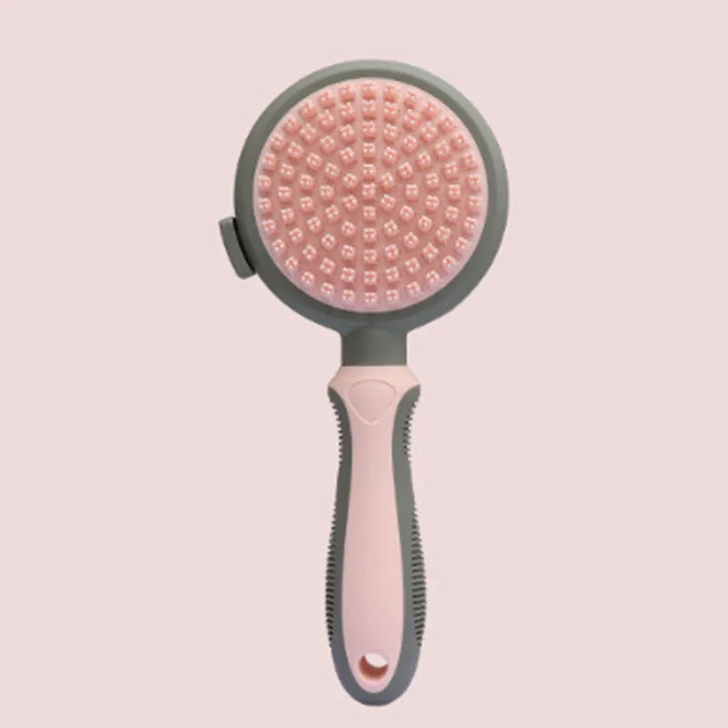 Green and pink dual-sided pet grooming brush with silicone massager and retractable slicker brush.