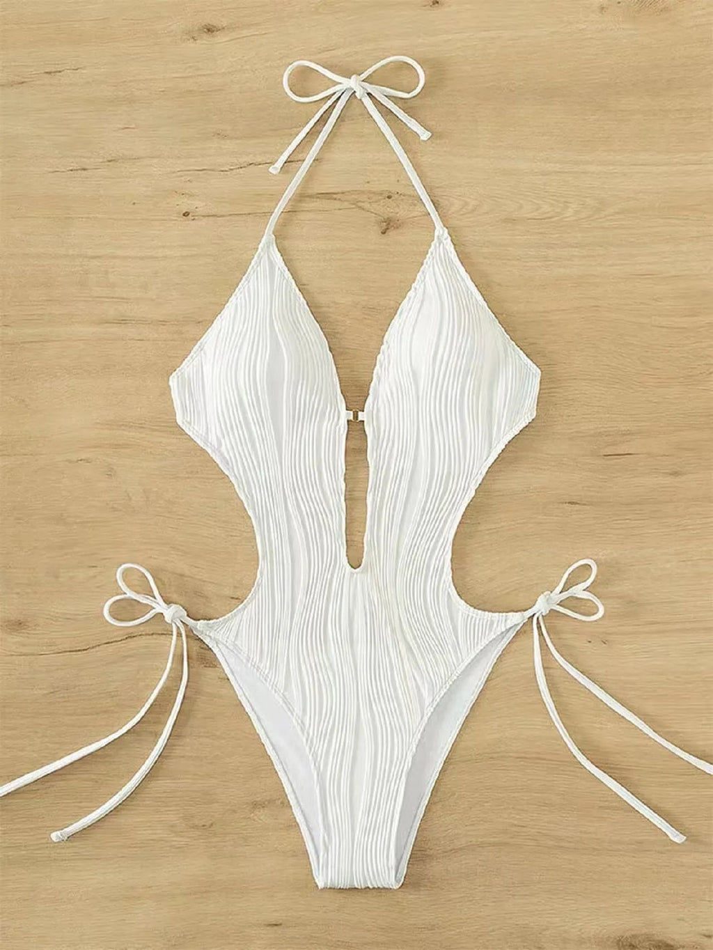 Women's black lace up triangle bikini swimsuit on solid colour background