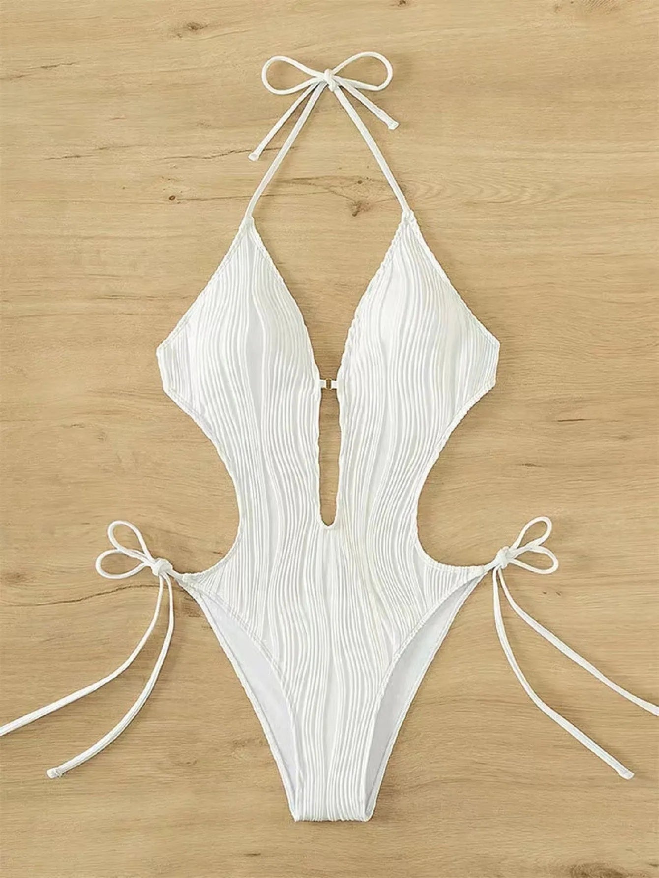 Women's black lace up triangle bikini swimsuit on solid colour background