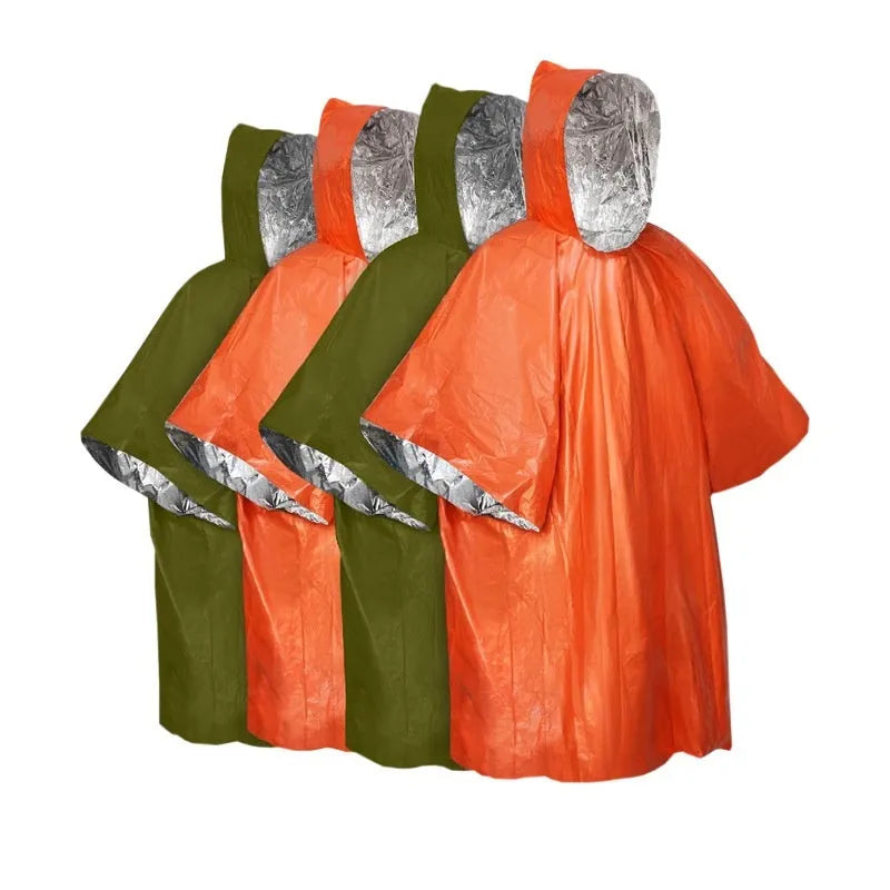 Adult in orange Marathon Wild cross-country rain poncho outdoors in rain.