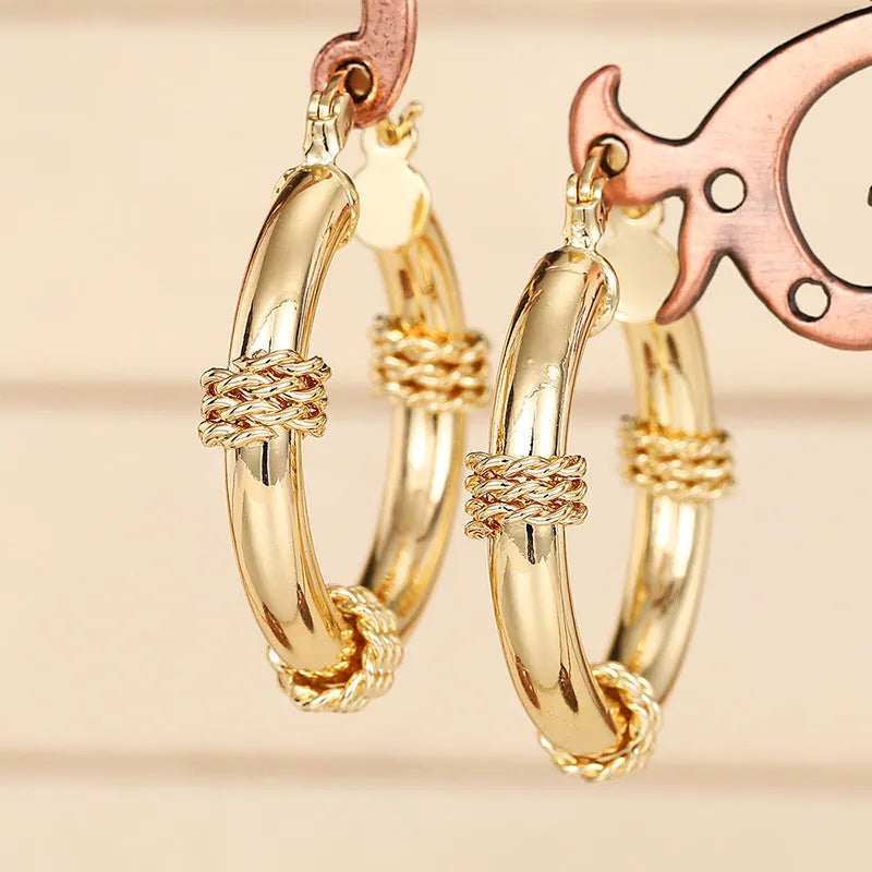 Geometric women's earrings with ring ear clip design in golden copper material