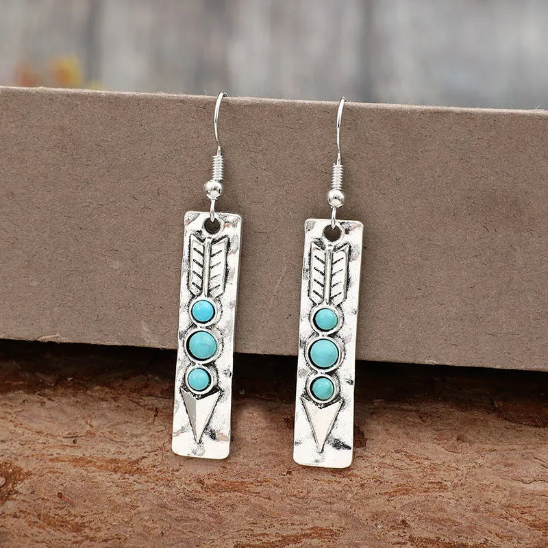 Silver-coloured geometric earrings with turquoise inlay measuring 20-24cm long