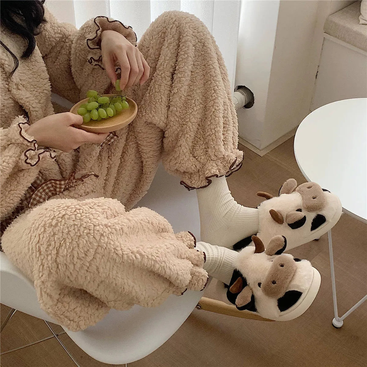 White cow-themed women's plush slippers with faux fur upper and textured non-slip sole