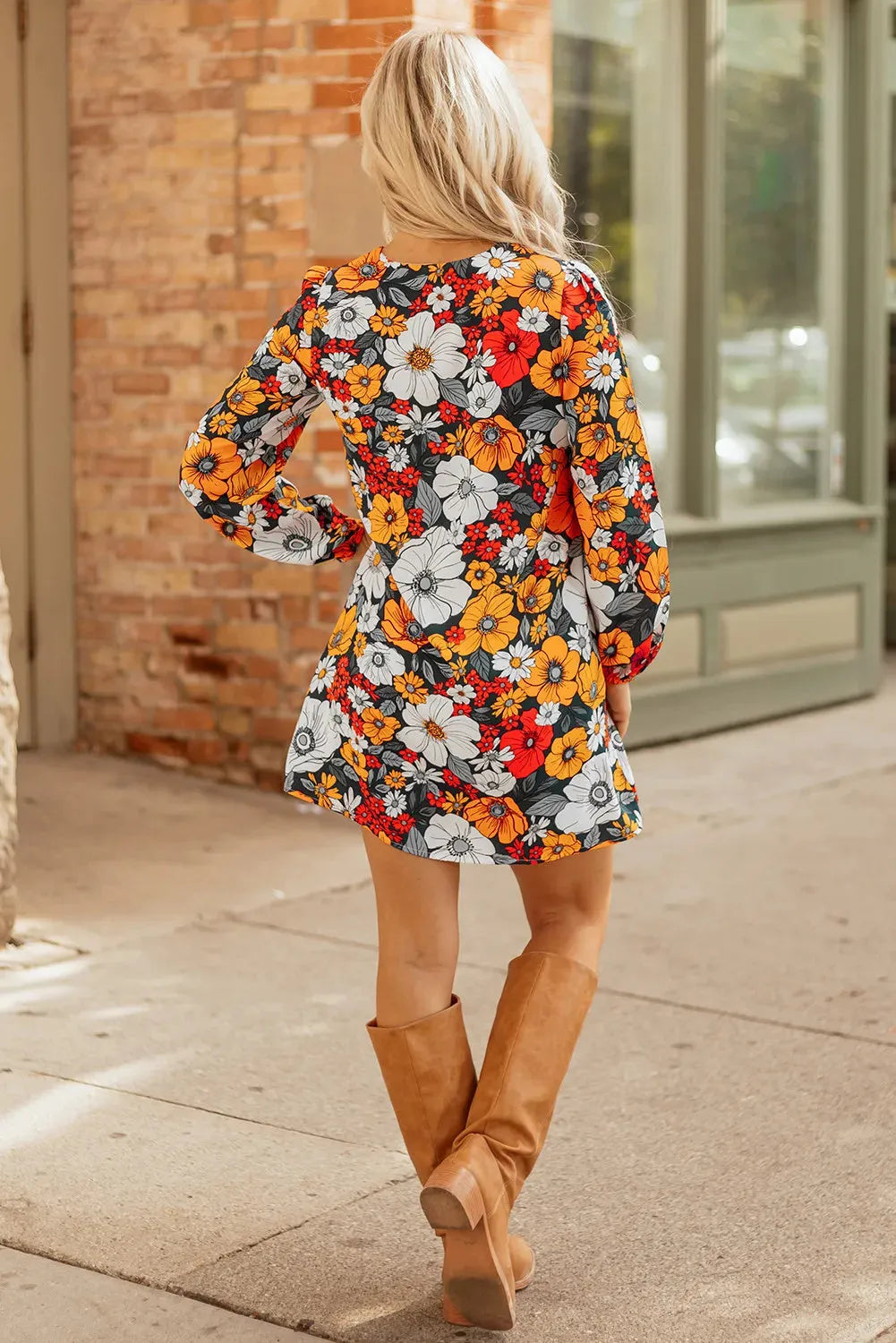 Orange floral print mini dress with striped lace detailing, V-neck, and long sleeves.
