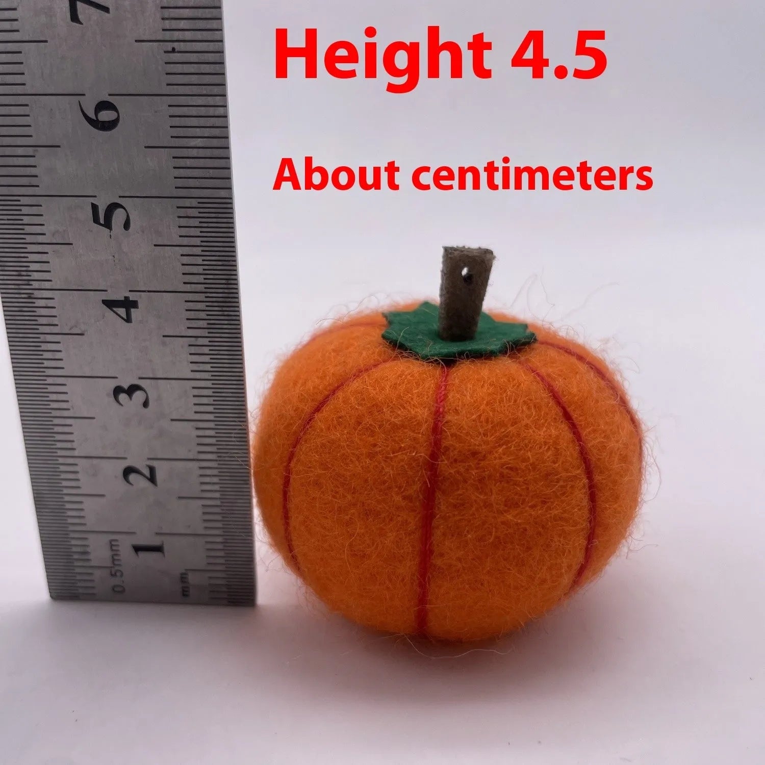 Wool felt pumpkin ornament measuring 5cm diameter in autumn colours for miniature displays