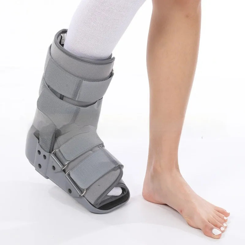 Grey and black Achilles tendon rehabilitation boot with plastic shell, aluminium struts, and adjustable nylon straps.