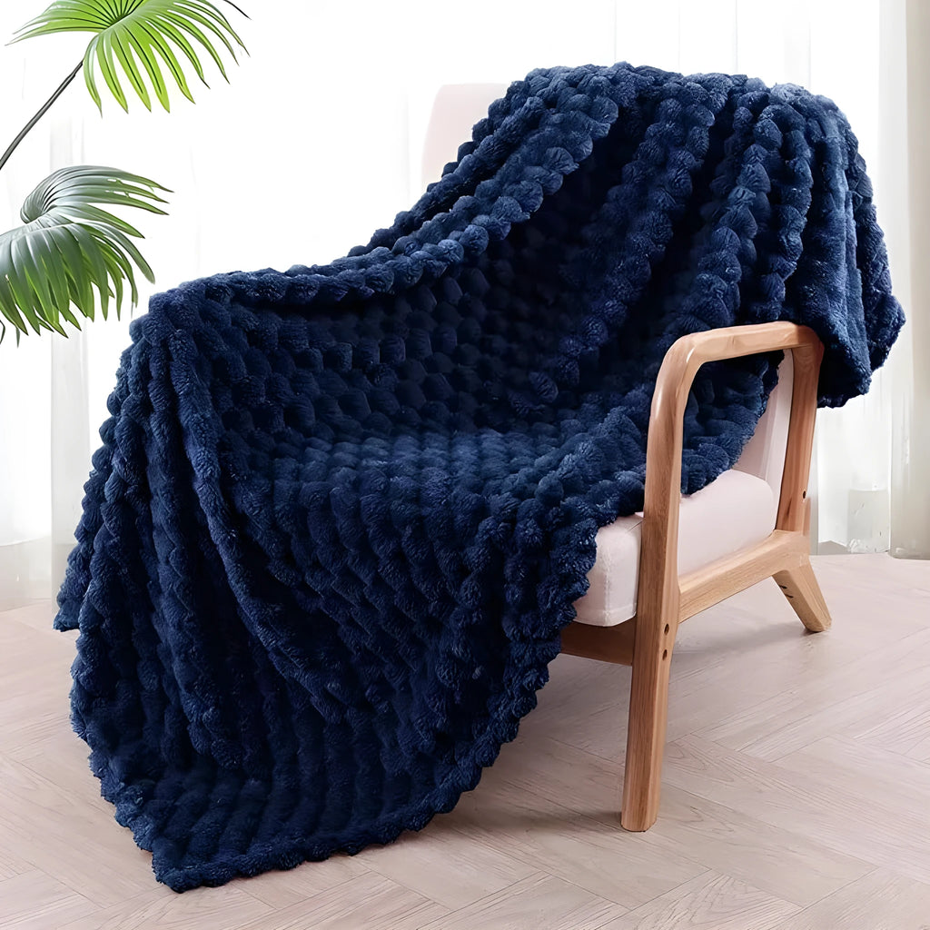 Children's soft plaid polyester blanket in camel colour on a bed