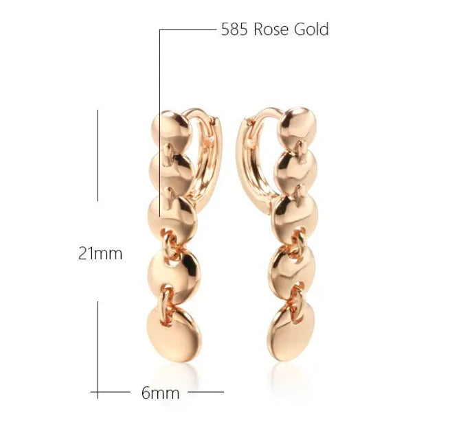 Retro long round copper earrings with woven design in a gold colour finish.