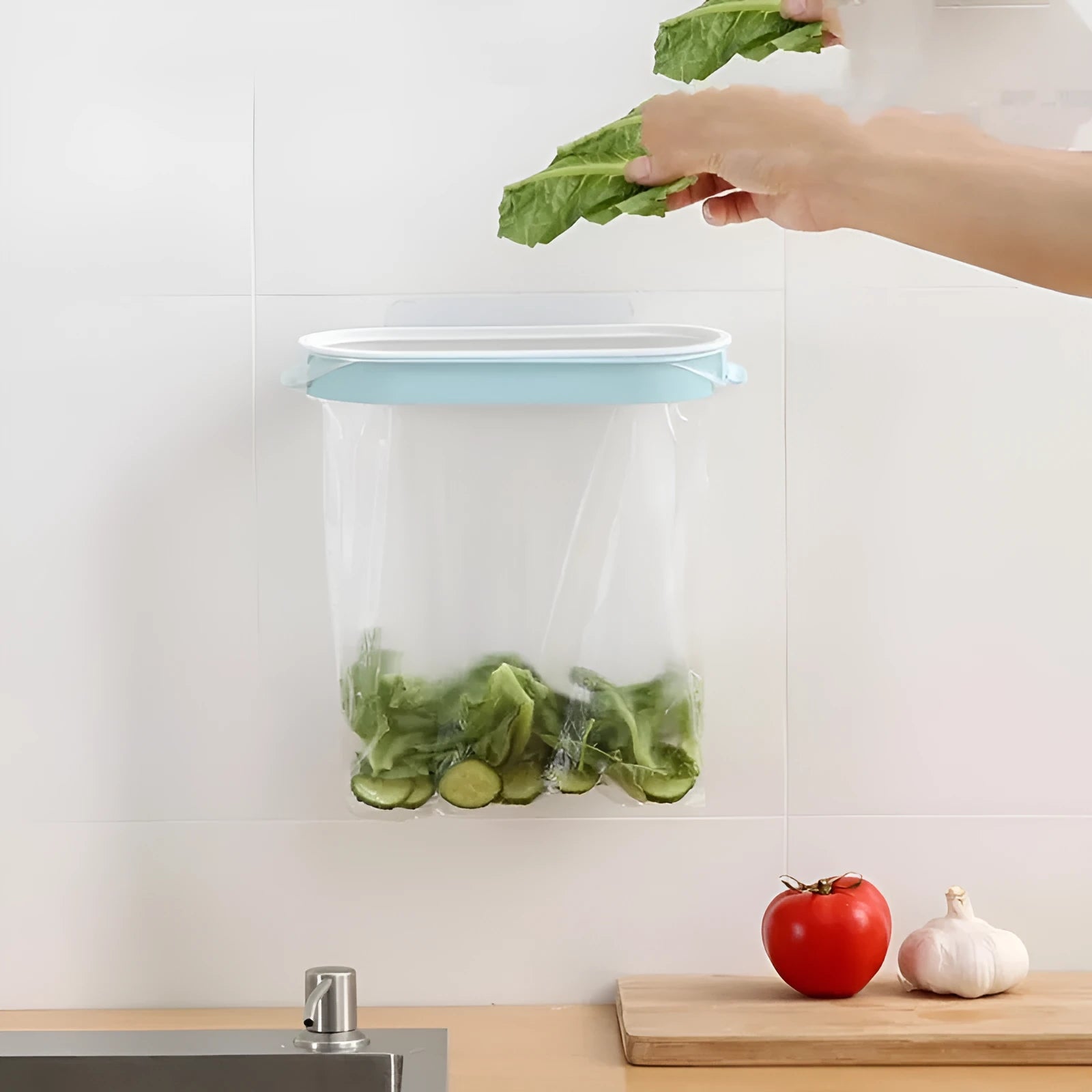Blue plastic kitchen garbage bag storage rack on a worktop.