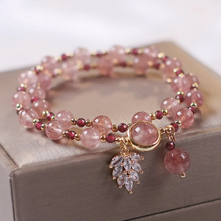 Women's double layer strawberry quartz bracelet with lucky cat charm in red cat's eye flowers colour.