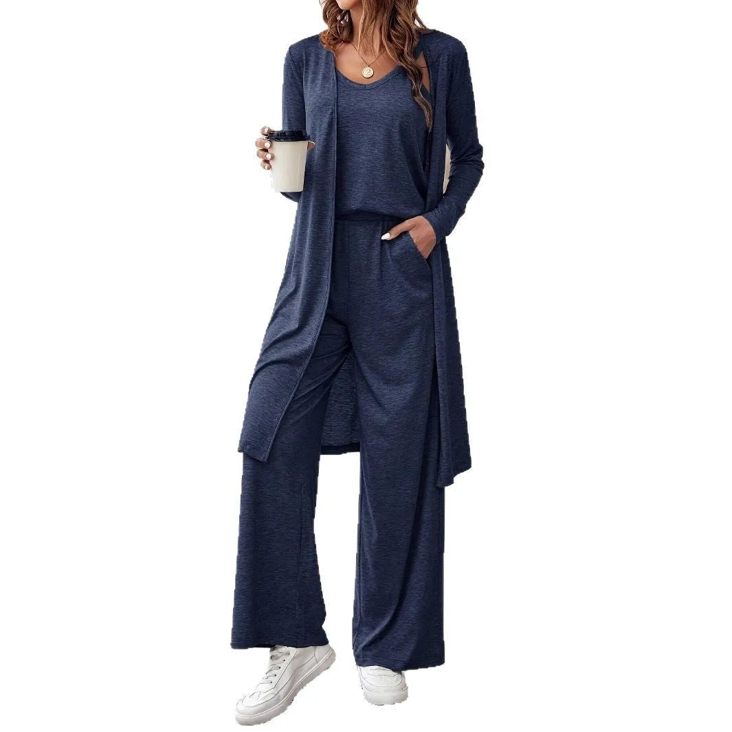 Blue women's three-piece casual suit set comprising sling top, long cardigan, and trousers on a hanger.