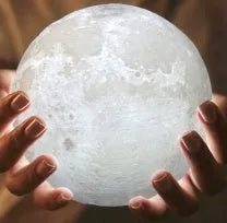 3D printed white moon lamp with textured surface on a wooden stand, showing touch ring at base.