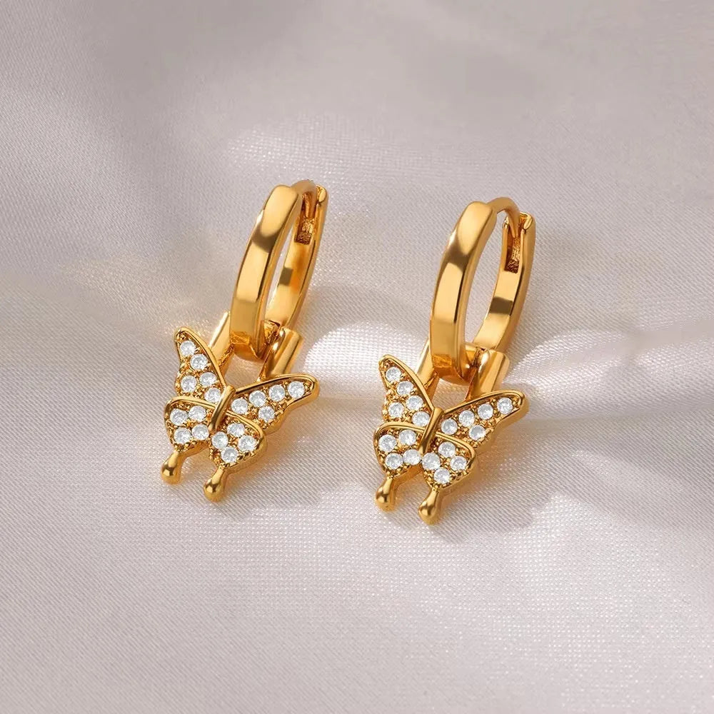 Women's geometric butterfly-shaped copper earrings with heart and star details in assorted colours.