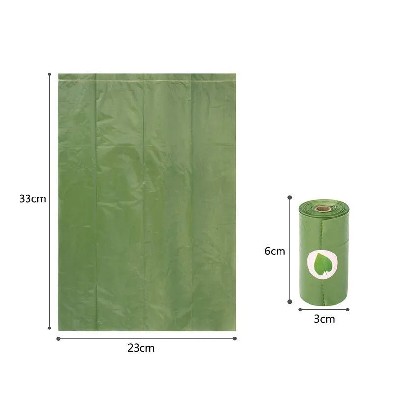 Roll of green EPI degradable pet garbage bags next to a boxed set with a dispenser.