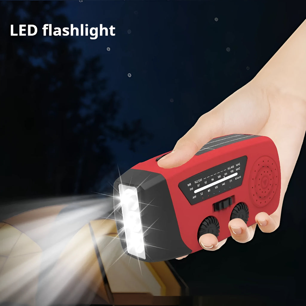 Red rechargeable emergency hand radio and torch with USB port, wrist strap, and display screen.