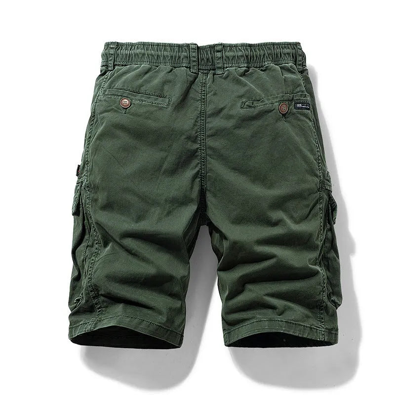 Men's army green cotton shorts with zipper and multiple pockets, shown on a hanger.