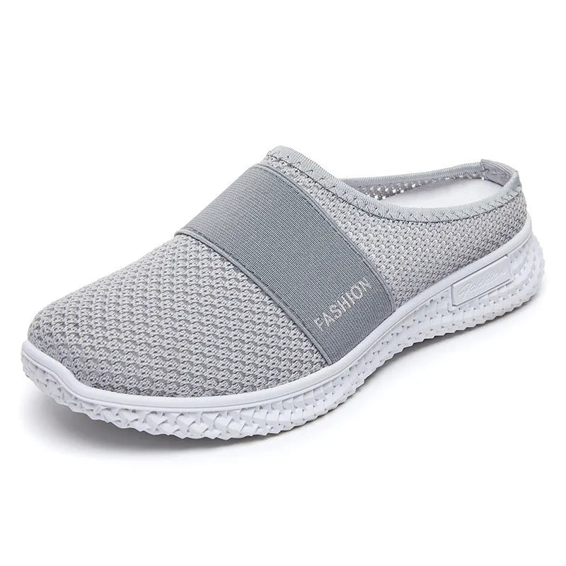 Women's flat casual shoes in mesh fabric with hollow-out design on a round toe.